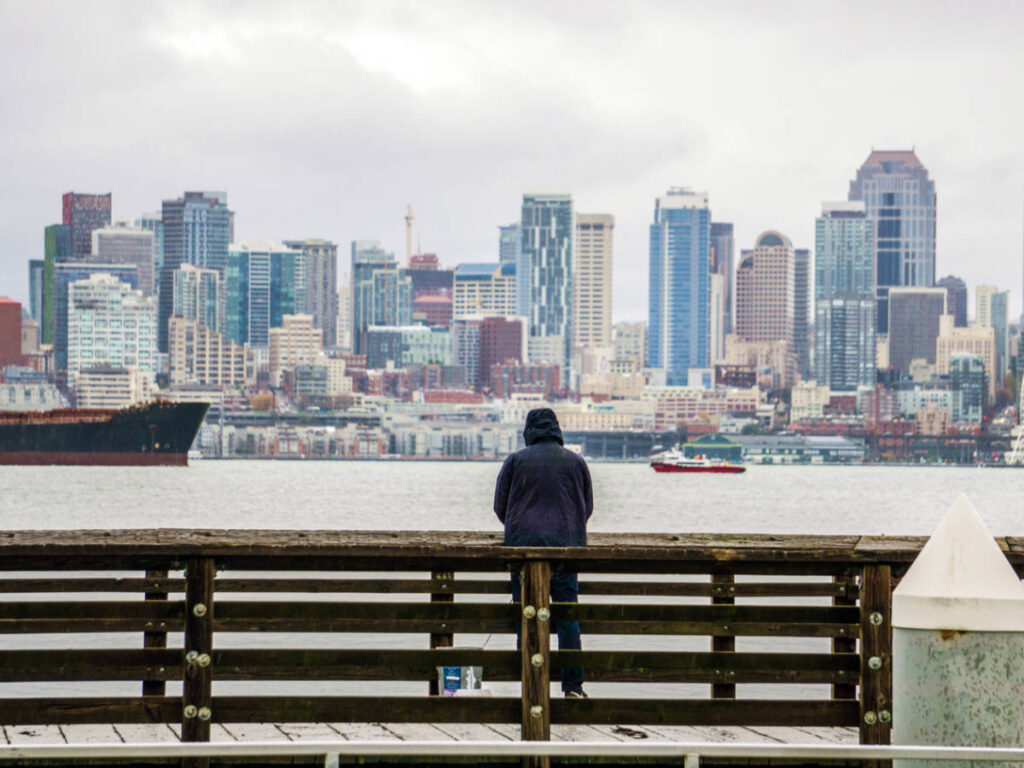 A man admiring the Seattle skyline on a gloomy day