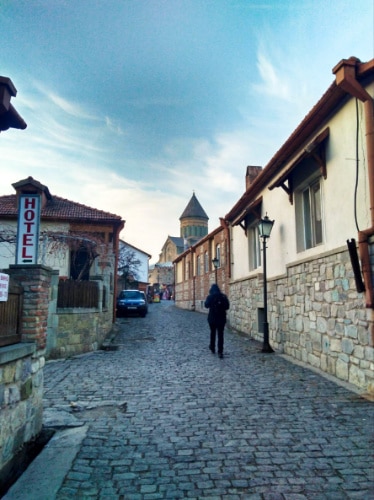A man walking to the Svetitskhoveli Cathedral in Mtskheta