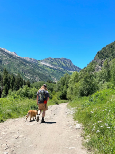 The author's husband and dog walking on the trail on a sunny day