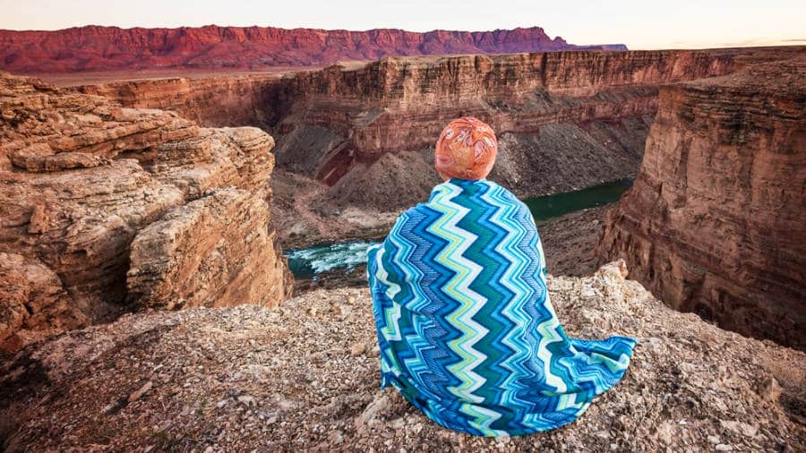 A man enjoying the overlooking view of the grand canyons and Green River in Utah