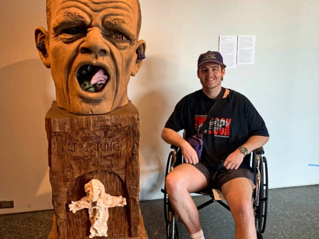 A man on a wheelchair near the sculpture at Phoenix Art Museum
