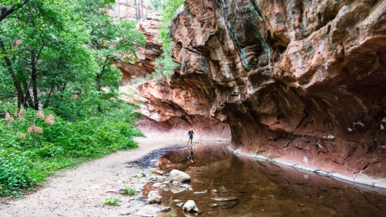 A man posing near the rock formation in Oak Creek Canyon