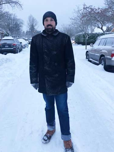 The author's husband standing on the middle of a street in Seattle during winter season