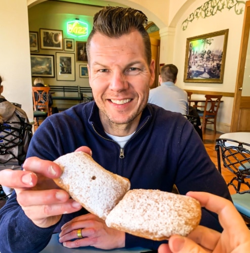 A man holding the Mickey beignets