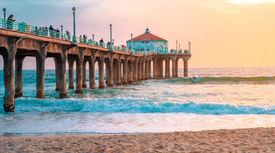 View of a pier in Manhattan State Beach during sunset