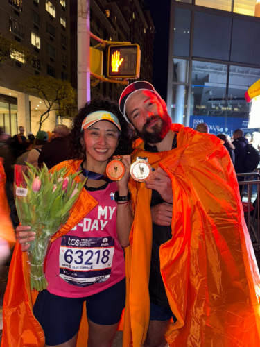 NYC Marathon finishers showing their medals