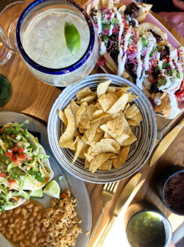 Top view of the variety of food and margarita from Lady Nomada