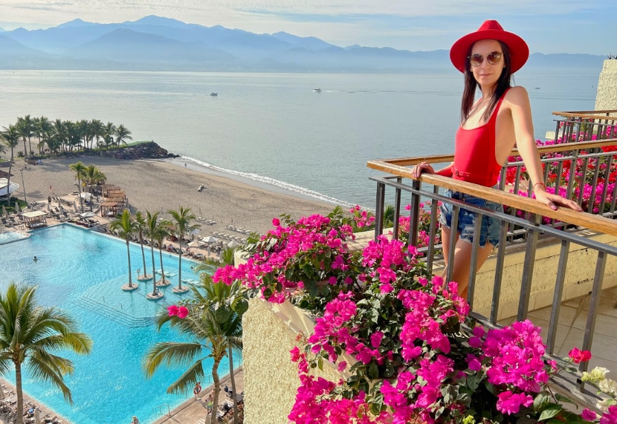 Clara on the balcony of Marriott Resort & Spa with the overlooking view of the pool and the ocean