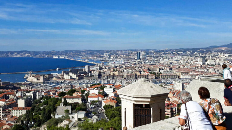 People enjoying the overlooking view of the city of Marseille