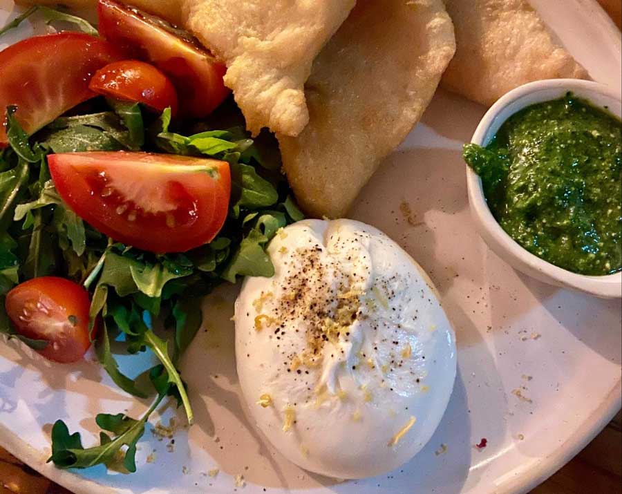 A burrata and gnocco fritto on a plate in Martello Hall