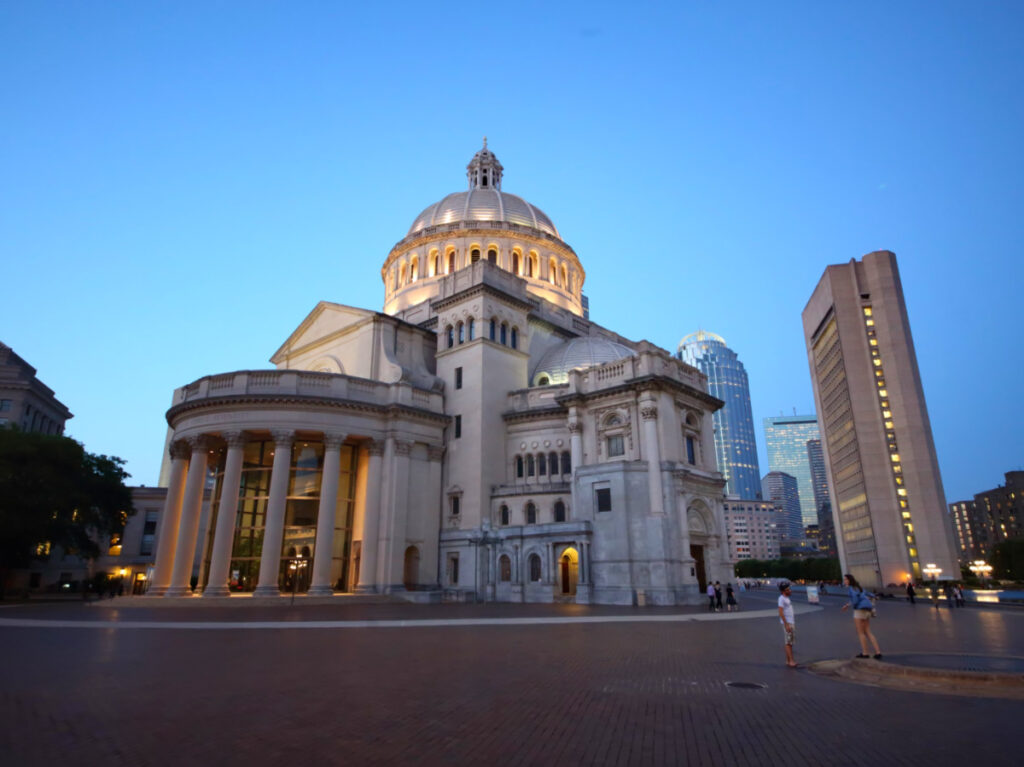 The outside view of Mary Baker Eddy Library and Christian Science Mother Church at an autumn evening