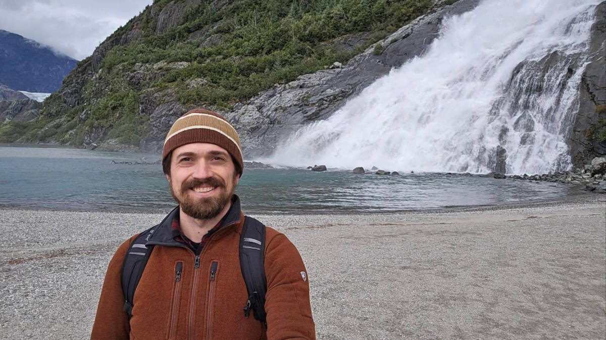 The author Matthew Reppond and a waterfall on his background