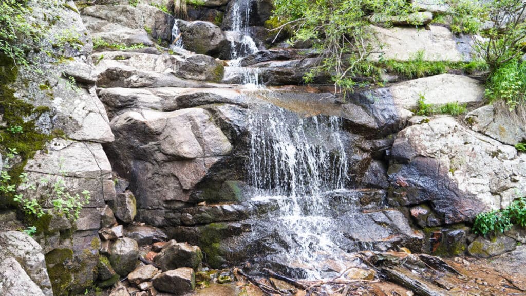 View of the cascading down Maxwell Falls on the huge rocks in Evergreen, CO