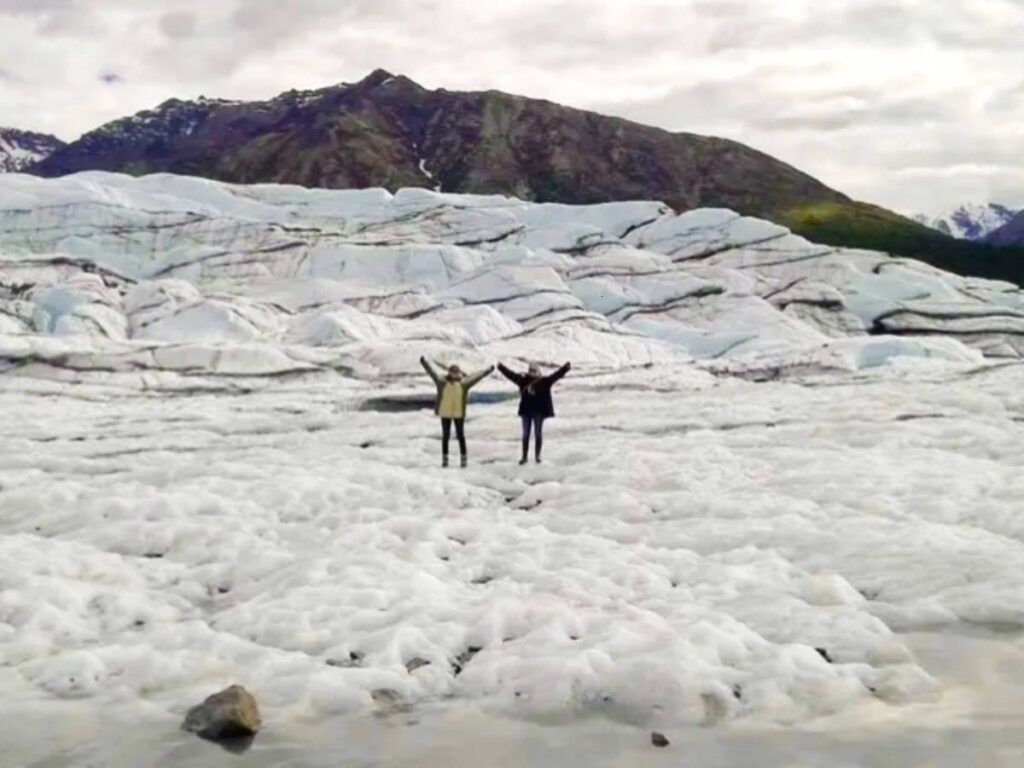 The author McKenna Mobley and her sister, posing for a photo in Matanuska Glacier in winter
