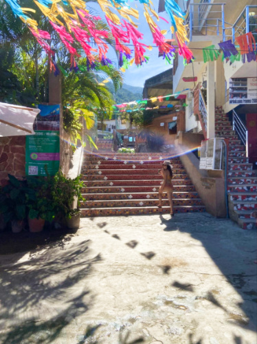 The author McKenna Mobley, posing on the stairs in Yelapa