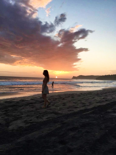 The author McKenna Mobley, enjoying the scenic sunset view at a beach in Limon