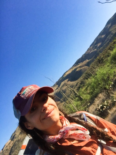 The author McKenna Mobley, smiling for a photo with the saguaros in the background