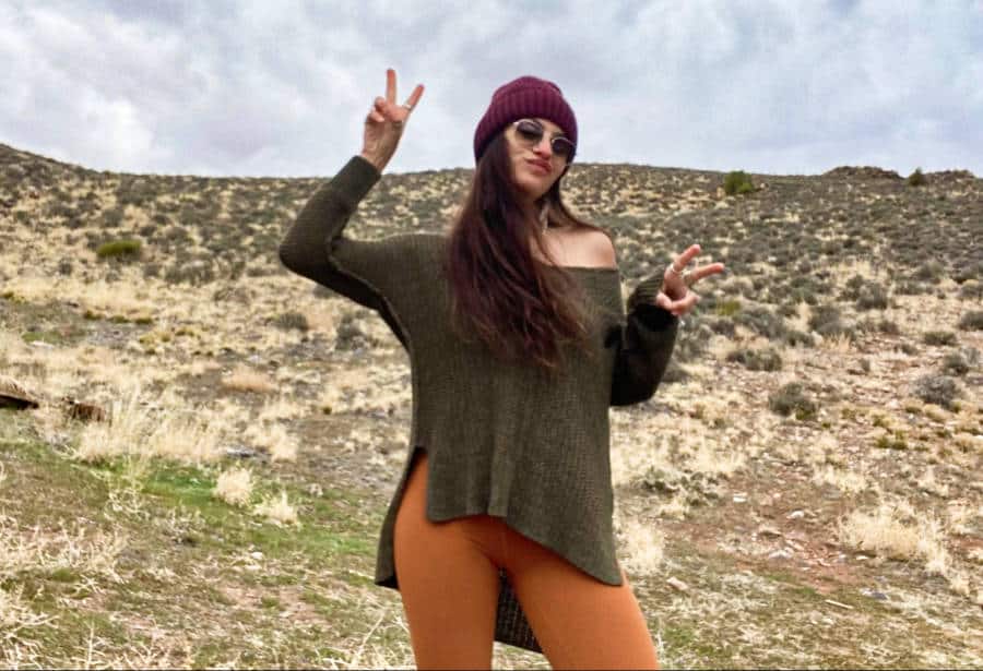 The author McKenna Mobley posing at a landscape in the countryside just outside of Moab