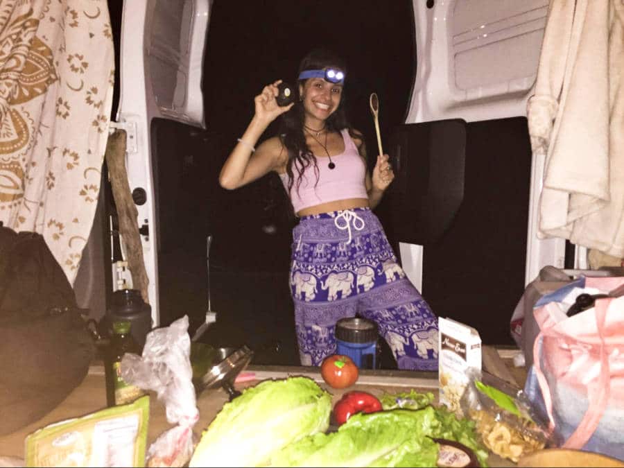 The author McKenna Mobley preparing to cook in her camper van
