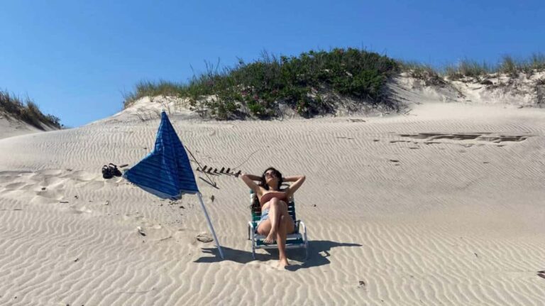 The author, McKenna Mobley on a beach chair at the white sand beach