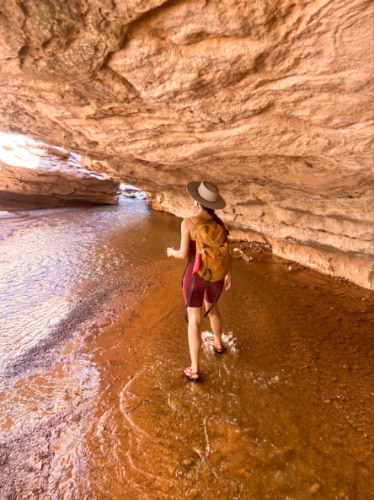 The author McKenna Mobley hiking along the Sulphur Creek trail surrounded by rock formations