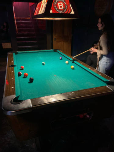 The author, McKenna Mobley playing pool at the Life of Riley