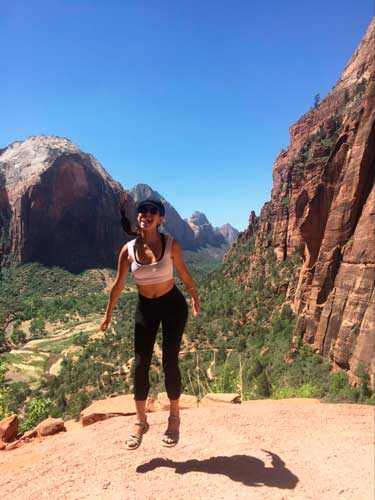 The author smiling for a photo during her hike at the Angels Landing