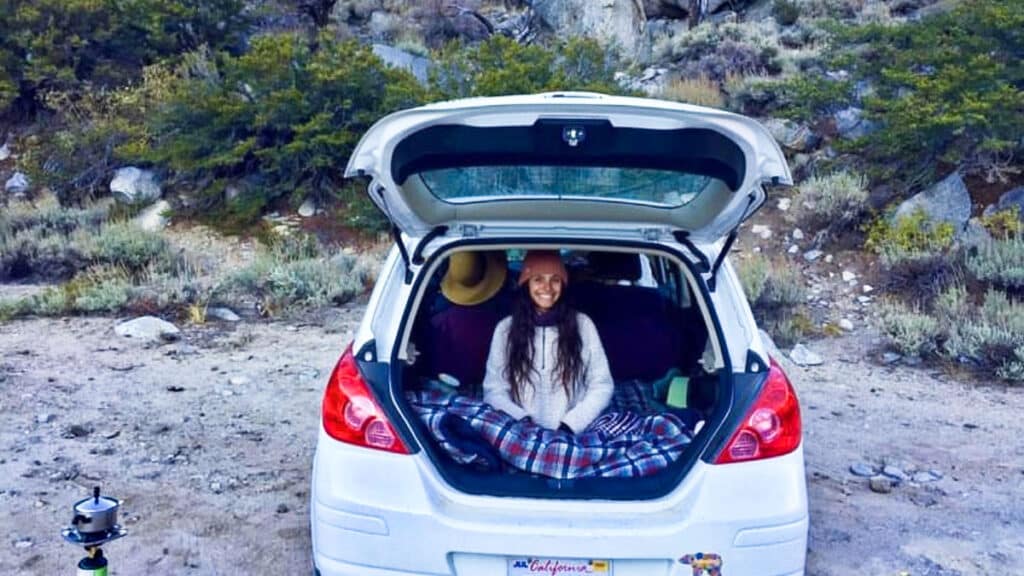 The author McKenna Mobley, preparing to sleep at the back of the car in Sierra Nevada mountains