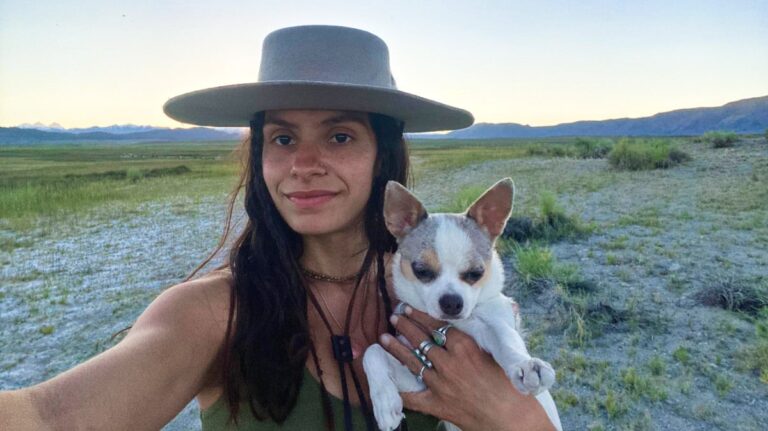The author McKenna Mobley with her dog, posing for a selfie at the campsite