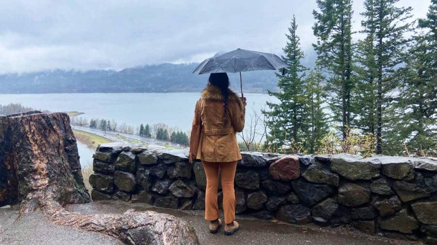 The author admiring view while holding an umbrella from the viewpoint in Portland on a rainy day