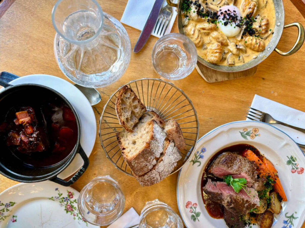 Beef Bourguignon, gnocchi, and steak served at Café des Musées