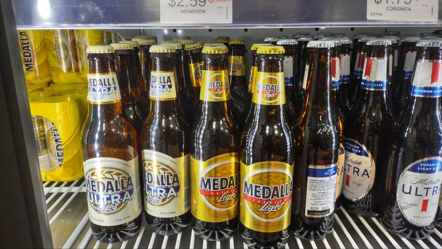 Bottles of Medalla Light displayed on a refrigerator