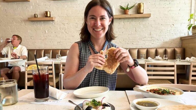 The author, Meg, holding a pita bread inside Shaya