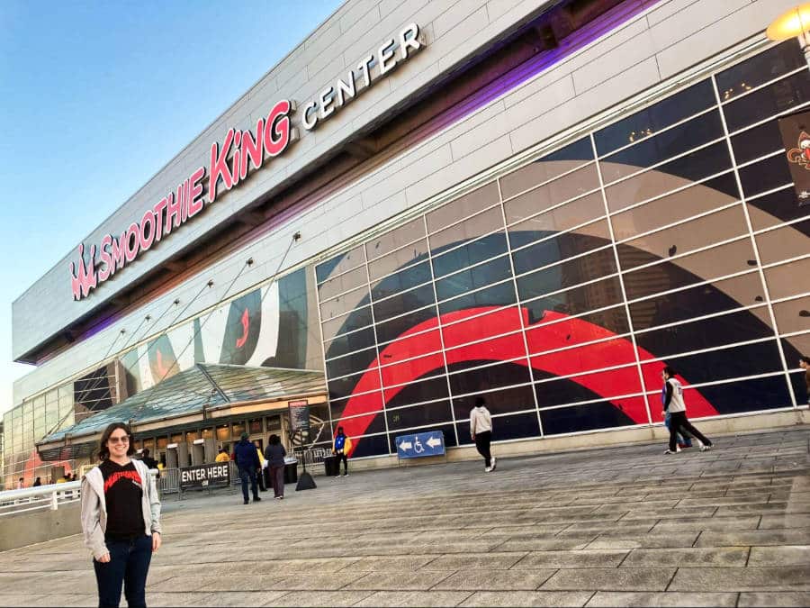 The author Meg O'Connor posing outside the Smoothie King Center 