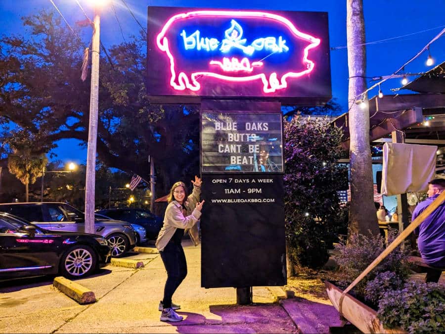 The author, Meg, posing beside the neon signage of Blue Oak BBQ