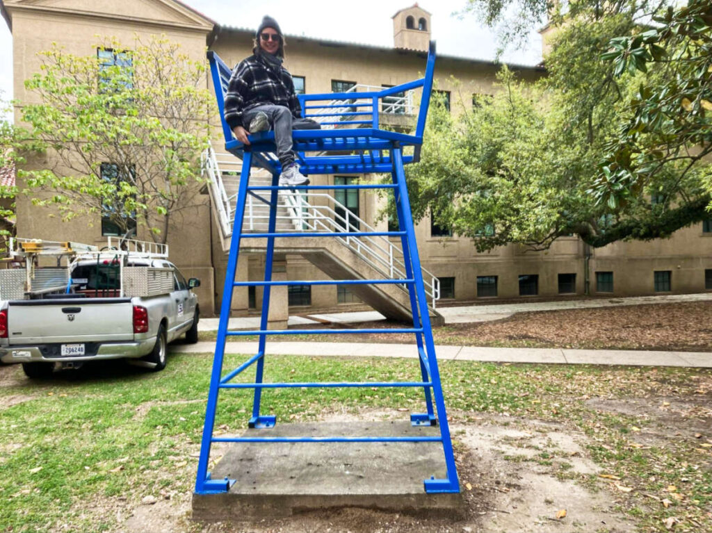 The author Meg O'Connor, sitting on one of the sculpture at the Louisiana State University Campus garden