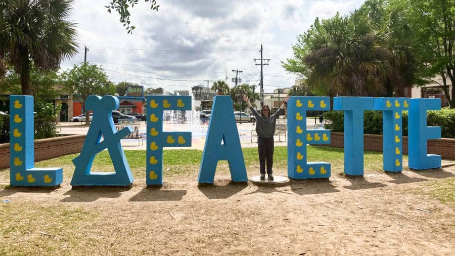 The author Meg posing as the Y in the “Lafayette” landmark signage