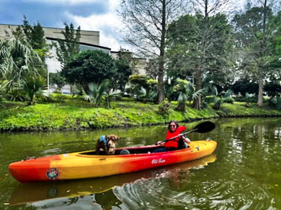 The author Meg and her dog Milo, kayaking at City Park