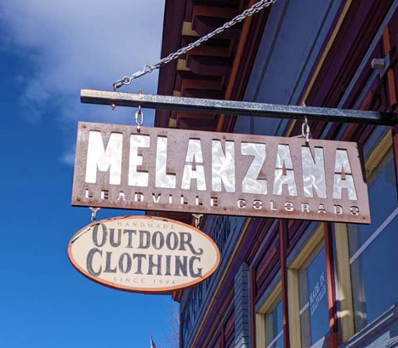 View of the Melanzana shop sign on the entrance
