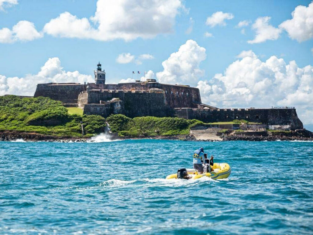 Two men riding a mini boat around San Juan
