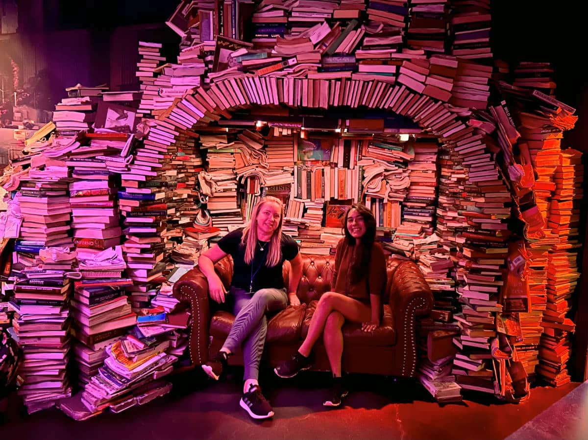 The author,, Laura Falin with Travel Lemming's editor, Abigail Bliss smiling for a photo in Meow Wolf Convergence Station