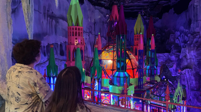 Kids looking at the colorful castle inside the Meow Wolf Denver