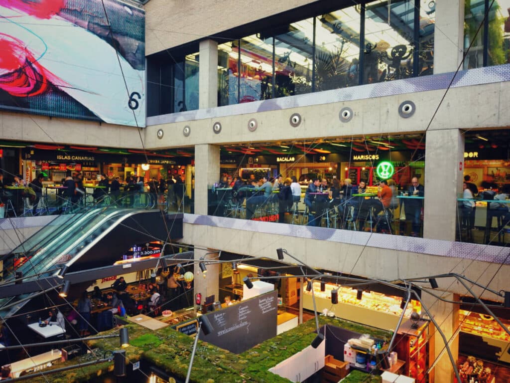 Locals and tourists inside the Mercado San Antón