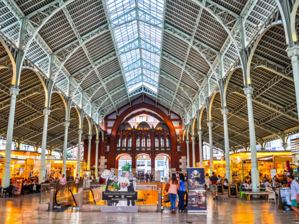 View of the high ceiling interior and the vendors around Mercado de Colon