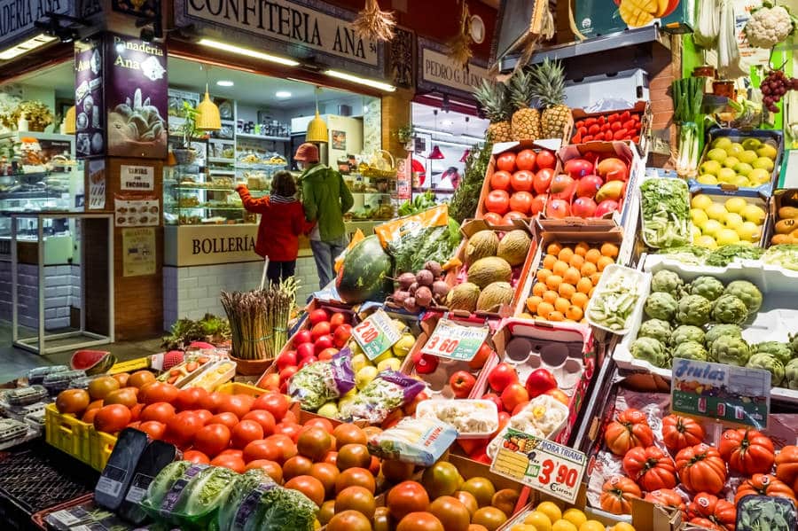 A stall with different and bright fruits and vegetables at the Mercado de Triana