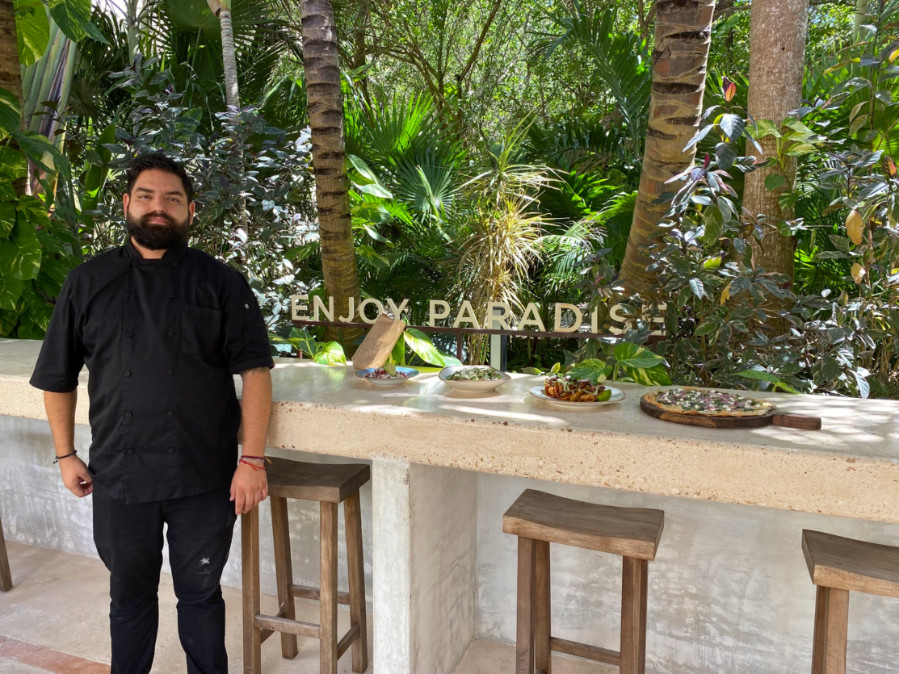 View of dishes on the table and the chef on Mereva Tulum standing on the side