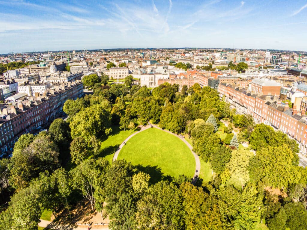 Aerial view of the Merrion Square surrounded by greenery and Dublin cityscape