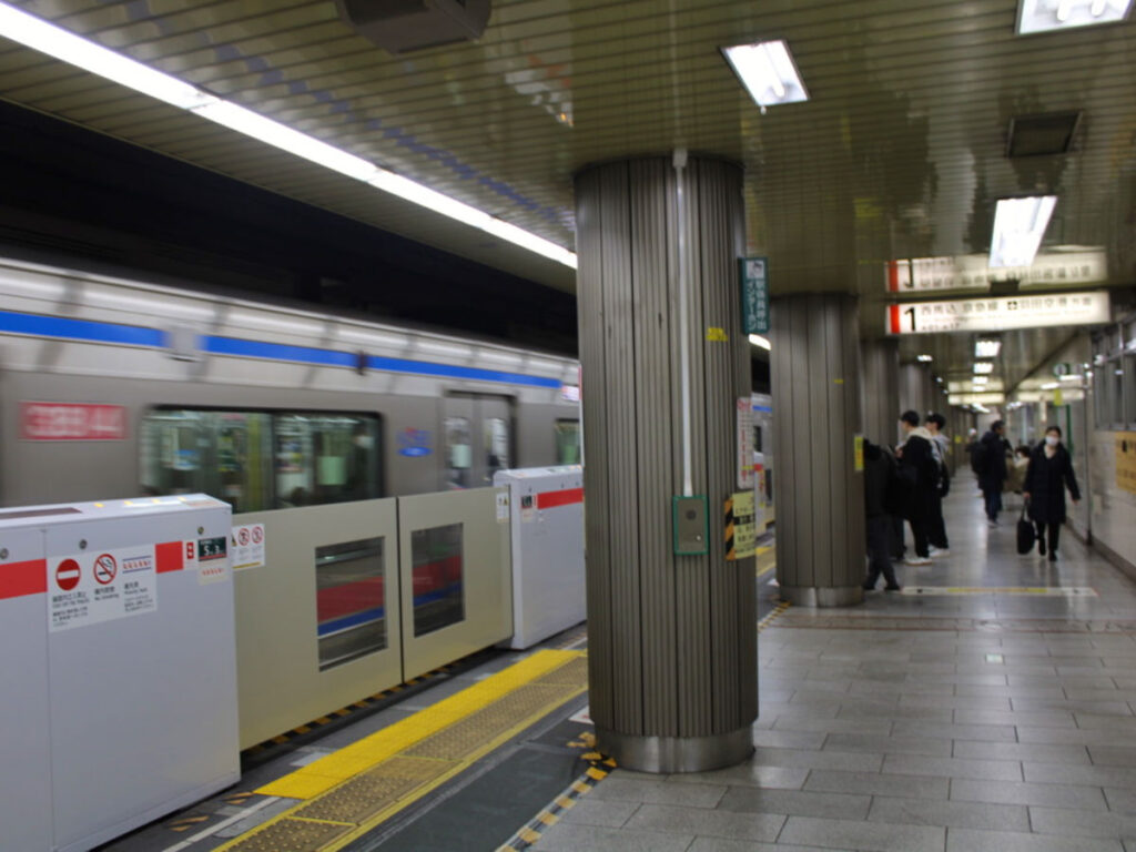 A Tokyo metro train speeding along the tracks