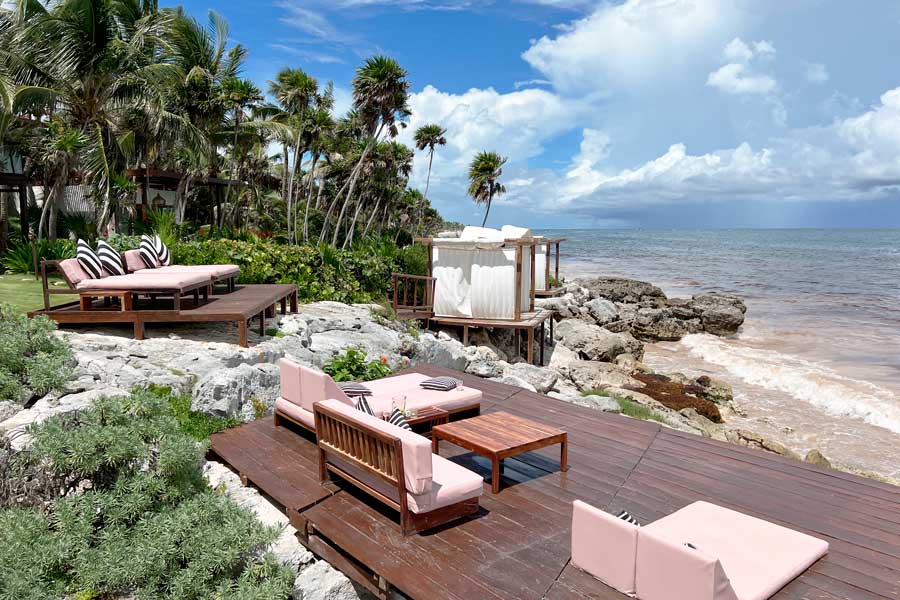 Couches and table on a beachfront area in Mi Amor a Colibri Boutique Hotel