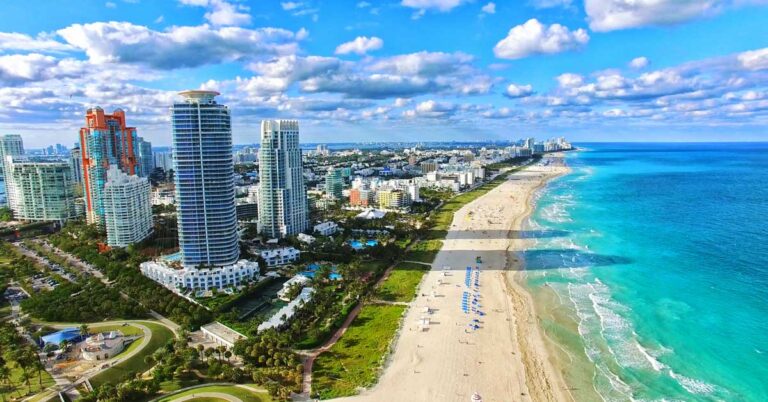 Aerial view of the blue water in Miami Beach and the clear blue sky